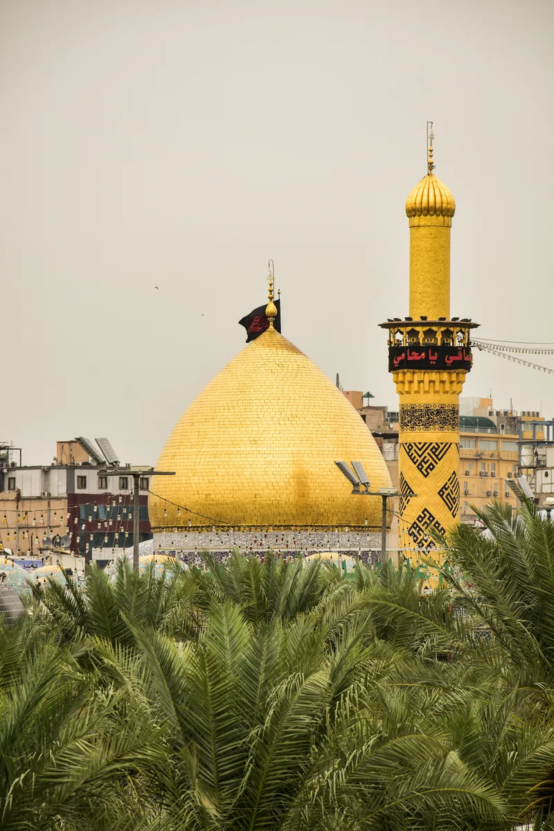 Imam Hussain shrine illuminated at night in Karbala, Iraq